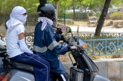 Wrapping up is common on motorcycles. Helmets are required for men, but not women.